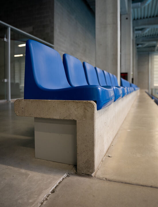 Blauwe kunststof kuipstoel op tribune